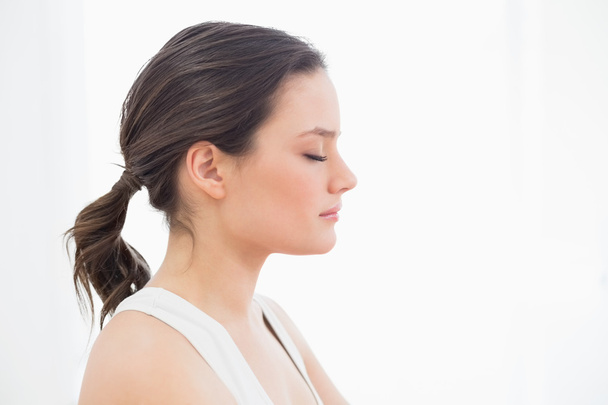 Close-up side view of a fit young woman with eyes closed - Photo, Image