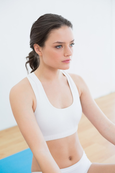 Toned brunette sitting at fitness studio - Foto, Imagen