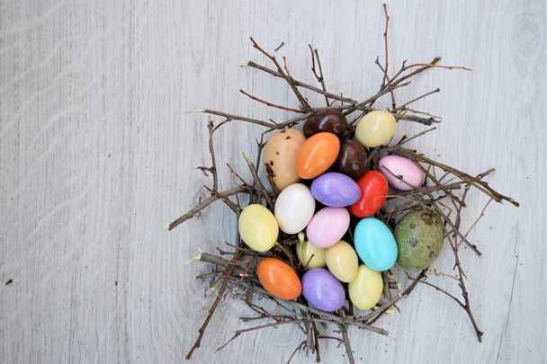 background of bird nest concept made of colorful candies in egg shape - Photo, Image