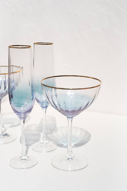 blue transparent cava glass set with sun light reflections - Fotoğraf, Görsel