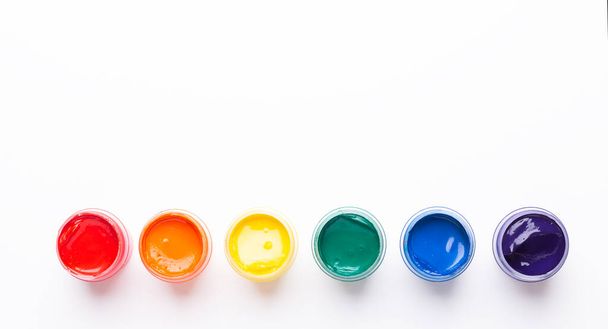 Six jars of paint on a white background Isolated Multicolored gouache Top view Copy space - Foto, Imagem