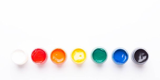 Multicolored gouache on a white background Isolated Paints in containers Top view Copy space Banner Horizontal - Valokuva, kuva