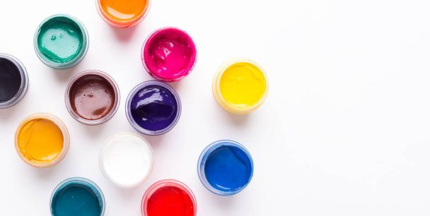 Multicolored gouache on a white background Isolated Paints in containers Top view Copy space - Foto, immagini