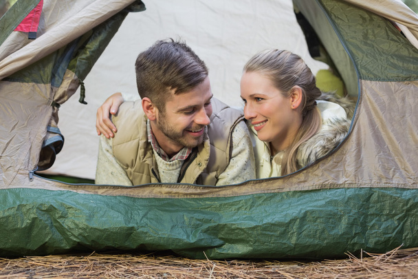 Smiling couple lying in tent after a hike - Fotoğraf, Görsel