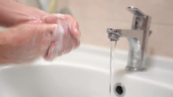 Process of carefully washing dirty hands with disinfectant soap under flowing warm water, foam on hands for cleansing. Dirty hands are under the risk to be infected with bacteria, microbe or different - Video