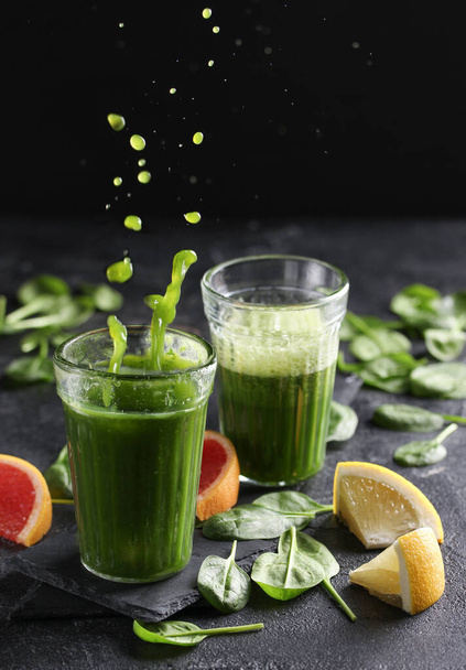 The concept of healthy kitchen. Smoothies with herbs, spinach on a dark background. Background image, copy space - Foto, immagini