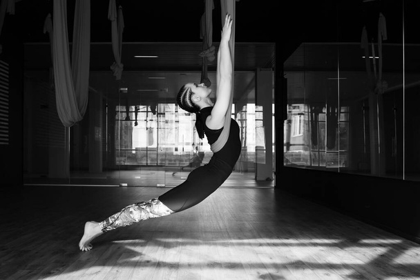 Woman at yoga training, fly yoga, aerostretching, therapy concept. - Zdjęcie, obraz