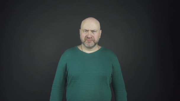 bald man with grey stubble performs emotions of anger - Footage, Video