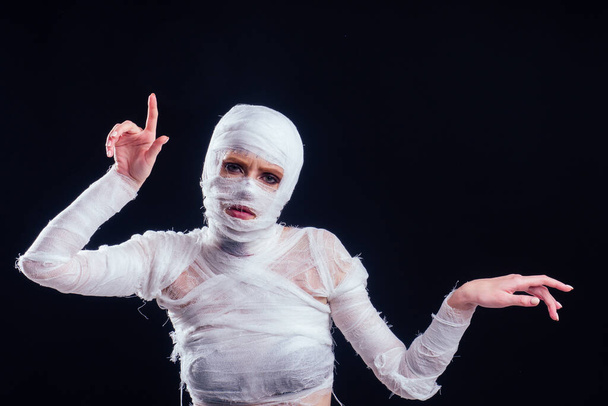 Glamorous mummy woman in bandages all over her body studio black background - Valokuva, kuva