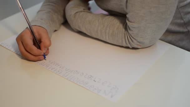 Little girl kid learn to write with numbers pen on a piece of paper - Filmagem, Vídeo