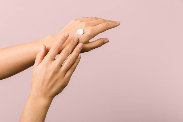 healthy hands of a young woman applying the SPF cream spring sun protection. skincare concept beauty photoshoot - 写真・画像