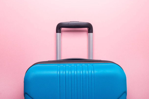 Blue suitcase on pastel pink background Summer holidays, vacation, travel concept Minimal Copy space - Foto, immagini
