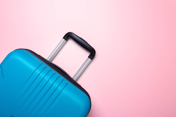 Blue suitcase on pastel pink background Summer holidays, vacation, travel concept Minimal Copy space - Fotoğraf, Görsel