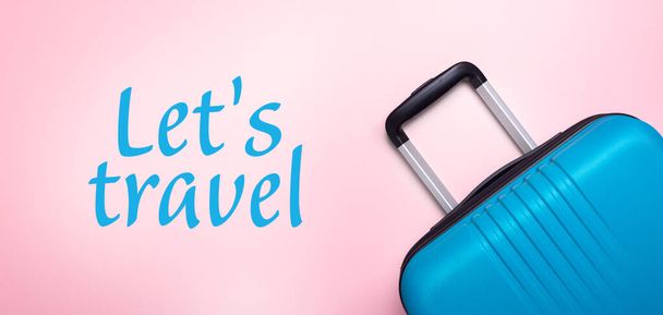 Words Let's Travel Blue suitcase on pastel pink background Summer holidays, vacation, travel concept Banner Minimal Copy space - Fotoğraf, Görsel