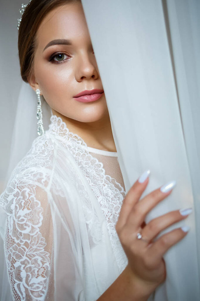 beautiful bride in a wedding morning in a bathrobe and veil - Photo, Image