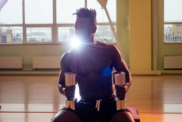 afro holding dumbbells workout for abc press and hands in gym windows background - Fotografie, Obrázek