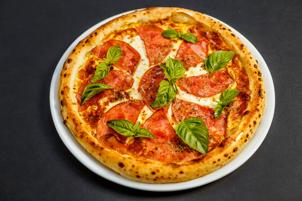hot italian pizza with cheese and basil, isolated - Foto, Imagen