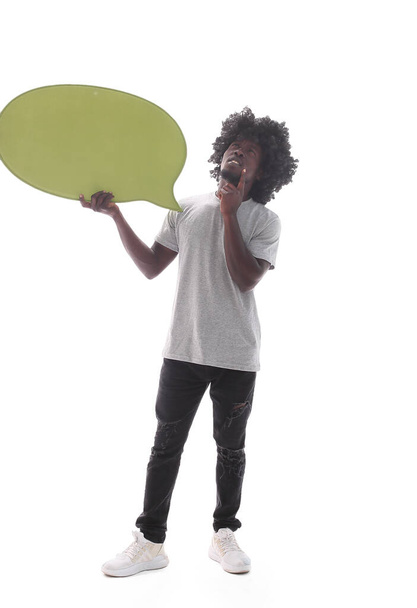 in full growth. curly-haired guy holding a speech bubble - Foto, imagen