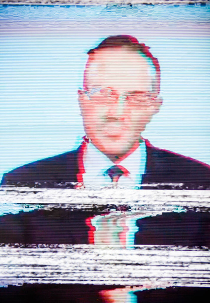 Man in a suit on the screen. Broadcaster. Glitch. Digital errors on the screen.  - Photo, Image