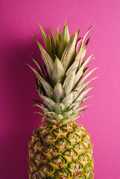 Fresh sweet pineapple on pink purple background, top view, cropped - Photo, Image