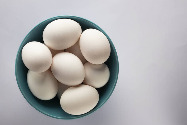 Chicken eggs on the table on white background - 写真・画像
