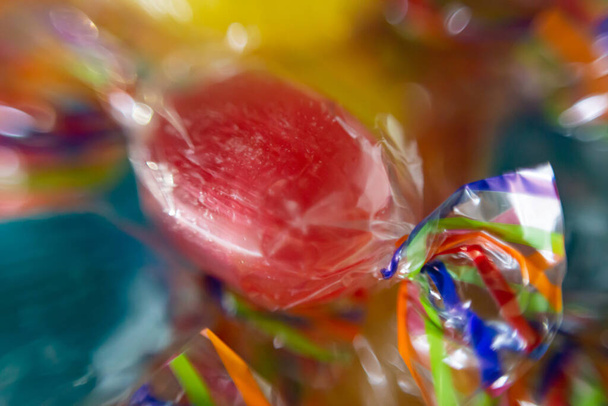 Macro shot of hard wrapped candy. Unhealthy food, sweets - Fotoğraf, Görsel