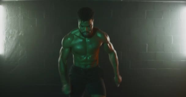 Man doing agility workout in dark gym - Materiał filmowy, wideo