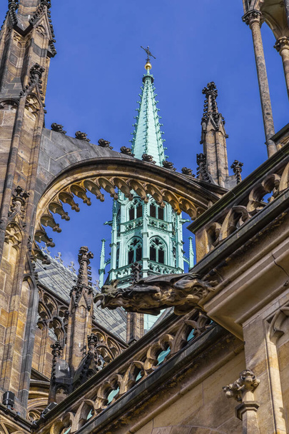 Prague, Czech Republic - One of the towers of St. Vitus Cathedral with a cross on top of the spire - Φωτογραφία, εικόνα