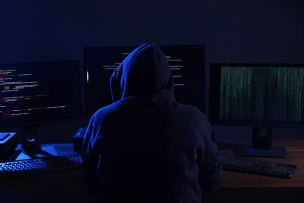 Hacker with computers in dark room. Cyber crime - Foto, afbeelding