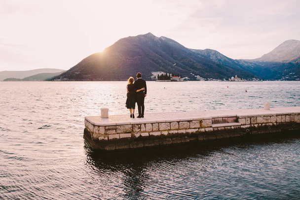 Couple travel on vacation in Europe, Montenegro. Romantic couple traveling in Europe, Perast. Man and woman embracing together. - Фото, зображення