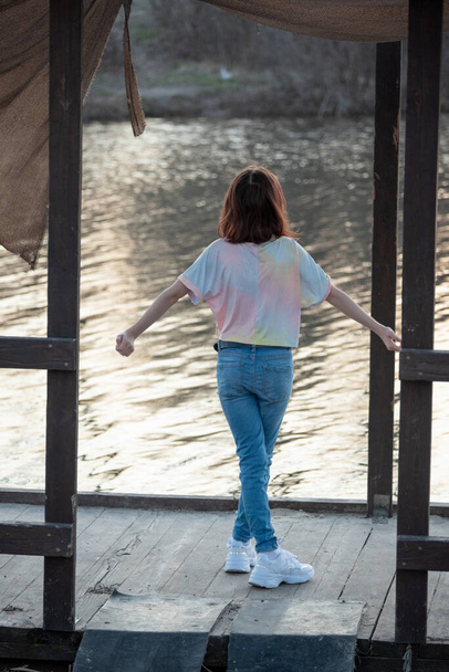 Portret van een mooie jonge vrouw. Fotoshoot in de lucht bij de rivier. Portret van een tiener. Meisje van 9 jaar. Schoolmeisjes lopen bij de rivier. De rivier. Meisje bij zonsondergang - Foto, afbeelding