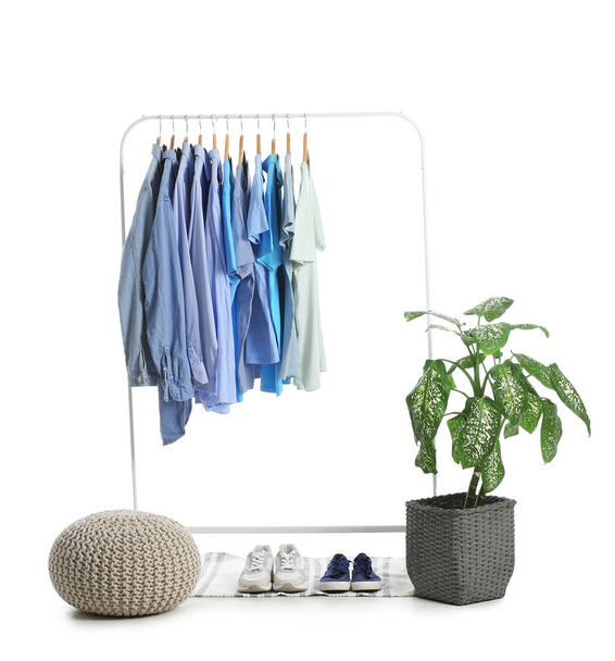 Rack with clothes and shoes on white background - Photo, Image