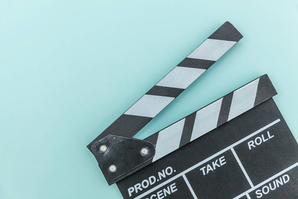 Filmmaker profession. Classic director empty film making clapperboard or movie slate isolated on blue background. Video production film cinema industry concept. Flat lay top view copy space mock up - Foto, Imagen