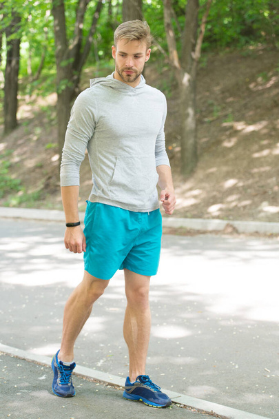 Fastest way to get in shape. Sportsman walk on sidewalk. Strong sportsman wear fitness uniform. Sportsman training outdoors. Sportsman or athlete. Healthy lifestyle. Sport and fitness. Daily workout - Photo, Image