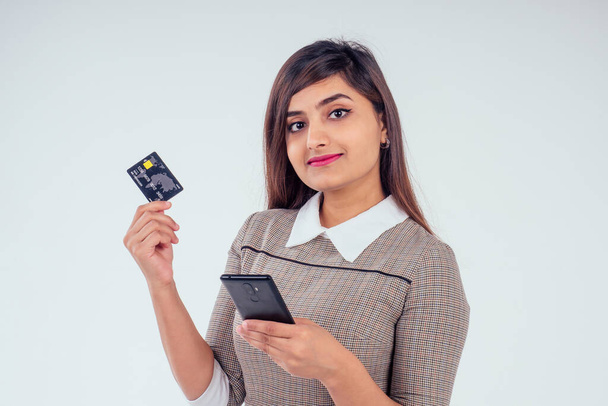 happy indian girl holding credit card in studio white background - Фото, изображение