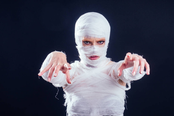 Glamorous mummy woman in bandages all over her body studio black background - Foto, imagen