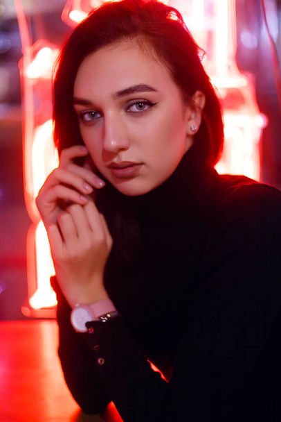 Phantom blue 2020 Trend.Portrait of a girl on the background of a neon sign of a shop window. Retrowave Style with Neon and Pink Lights. - Foto, imagen