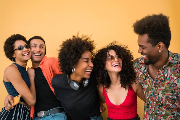 Portrait of Afro friends having fun together and enjoying good time against yellow background. Friendship and lifestyle concept. - Foto, immagini