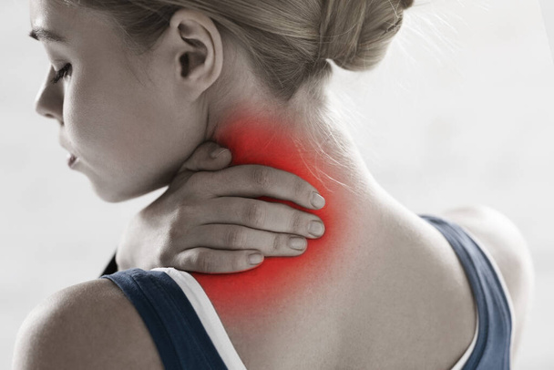 Athlete suffering from sports injury, feeling neck pain on white background - Photo, Image
