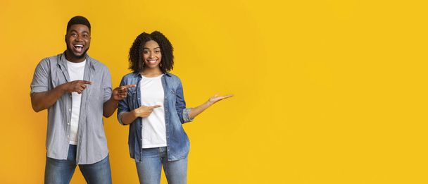 Excited Black Couple Pointing At Invisible Object In Girlss Hand - Photo, Image