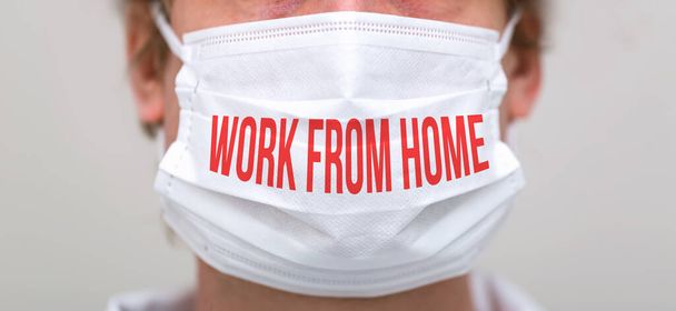 Work From Home theme with person wearing a protective face mask - Zdjęcie, obraz