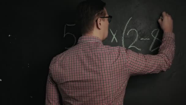 man writes math formula on blackboard - Footage, Video