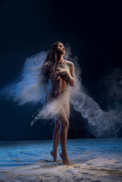 Slim girl in white dust cloud view - Photo, image