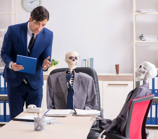 Funny business meeting with boss and skeletons - Foto, Imagem