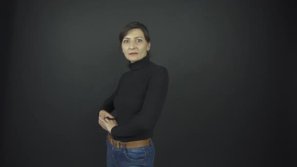 wonderful woman in black pullover and blue denim jeans poses - Footage, Video