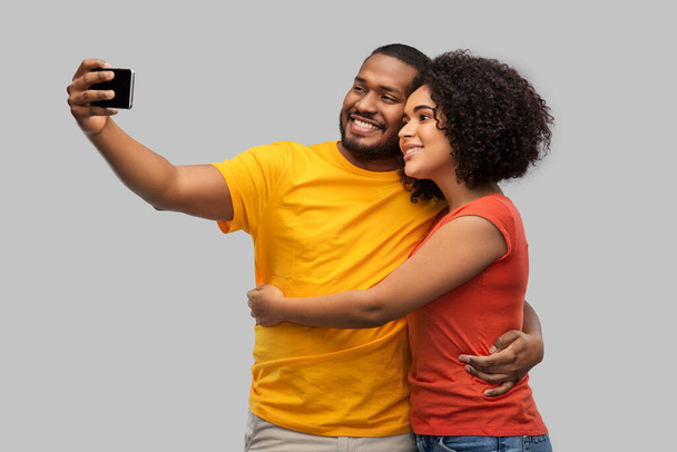 african american couple taking selfie by cellphone - Fotografie, Obrázek