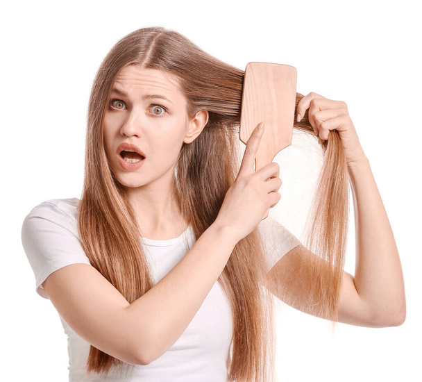 Bella giovane donna spazzolatura capelli su sfondo bianco
 - Foto, immagini