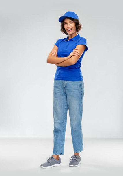 happy smiling delivery woman in blue uniform - Photo, image