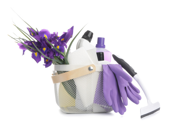 Set of cleaning supplies and spring flowers on white background - Photo, Image