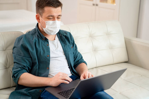 freelancer in medical mask working sitting. - Фото, зображення